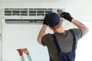 Technician Repairing Air Conditioner