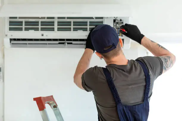 Technician Repairing Air Conditioner